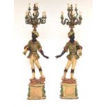 A pair of reproduction painted wood blackamoor standing lamps