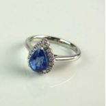 An 18ct white gold pear cut sapphire and diamond cluster ring