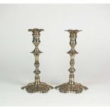A near pair of George II silver candlesticks