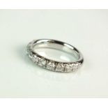A platinum diamond half hoop eternity ring
