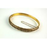 A Victorian 15ct gold hinged bangle