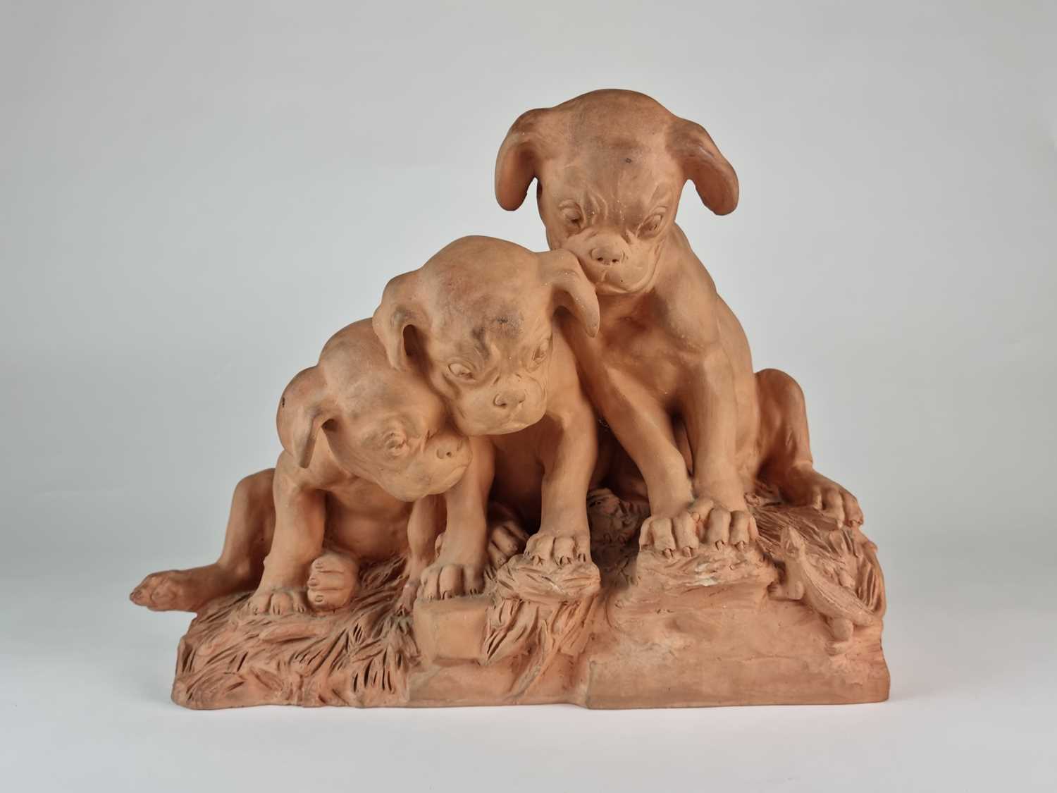 French terracotta group of three pug dog puppies looking at lizard, after Georges Lucien Vacossin