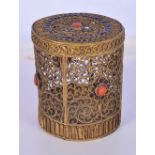 A small Islamic metal open work lidded box ornately formed with coral stone inserts 9cm.(2).