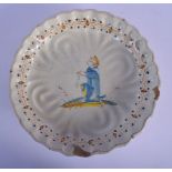 AN 18TH CENTURY ITALIAN FAIENCE TIN GLAZED RIBBED PEDESTAL DISH painted with a kneeling saint. 24 cm