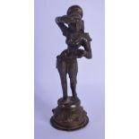 A 19TH CENTURY INDIAN BRONZE FIGURE OF A STANDING BUDDHIST DEITY modelled applying a motif to her fo