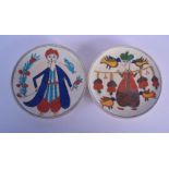 AN UNUSUAL PAIR OF TURKISH FAIENCE KUTAHYA CIRCULAR PLATES painted with figures. 15.5 cm diameter.