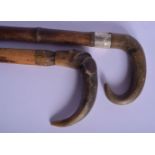 TWO 19TH CENTURY CONTINENTAL CARVED RHINOCEROS HORN WALKING CANES. 90 cm long. (2)