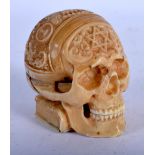 AN ANTIQUE IVORY SKULL CLOCK WITH MASONIC SYMBOLS CARVED ON THE SKULL AND A SECRET COMPARTMENT,ENT I