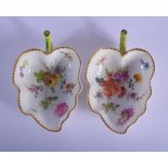 A PAIR OF 19TH CENTURY GERMAN PORCELAIN LEAF SHAPED DISHES painted with flowers. 10 cm x 7 cm.