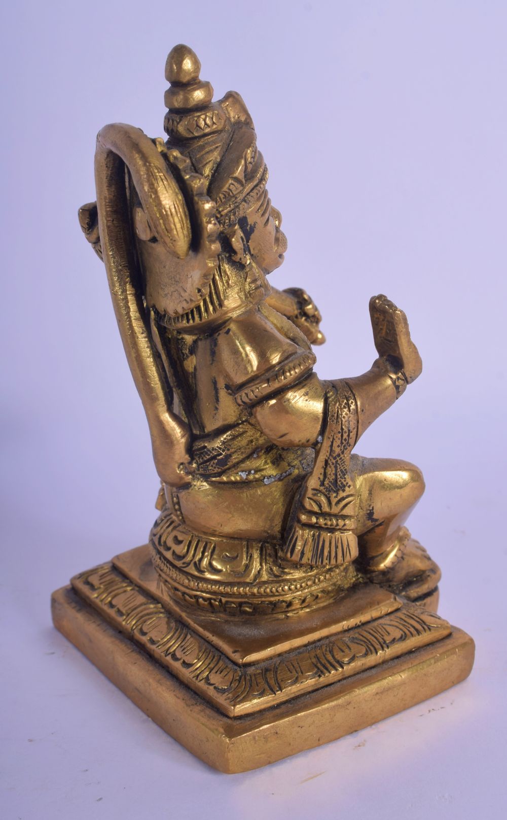 AN INDIAN BRONZE FIGURE OF A SEATED TIGER GOD modelled holding a sceptre. 12 cm x 6 cm. - Image 3 of 4