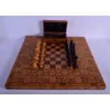 AN ANTIQUE BOXWOOD AND EBONY CHESS SET with similar parquetry type chess board. Board 54 cm square,