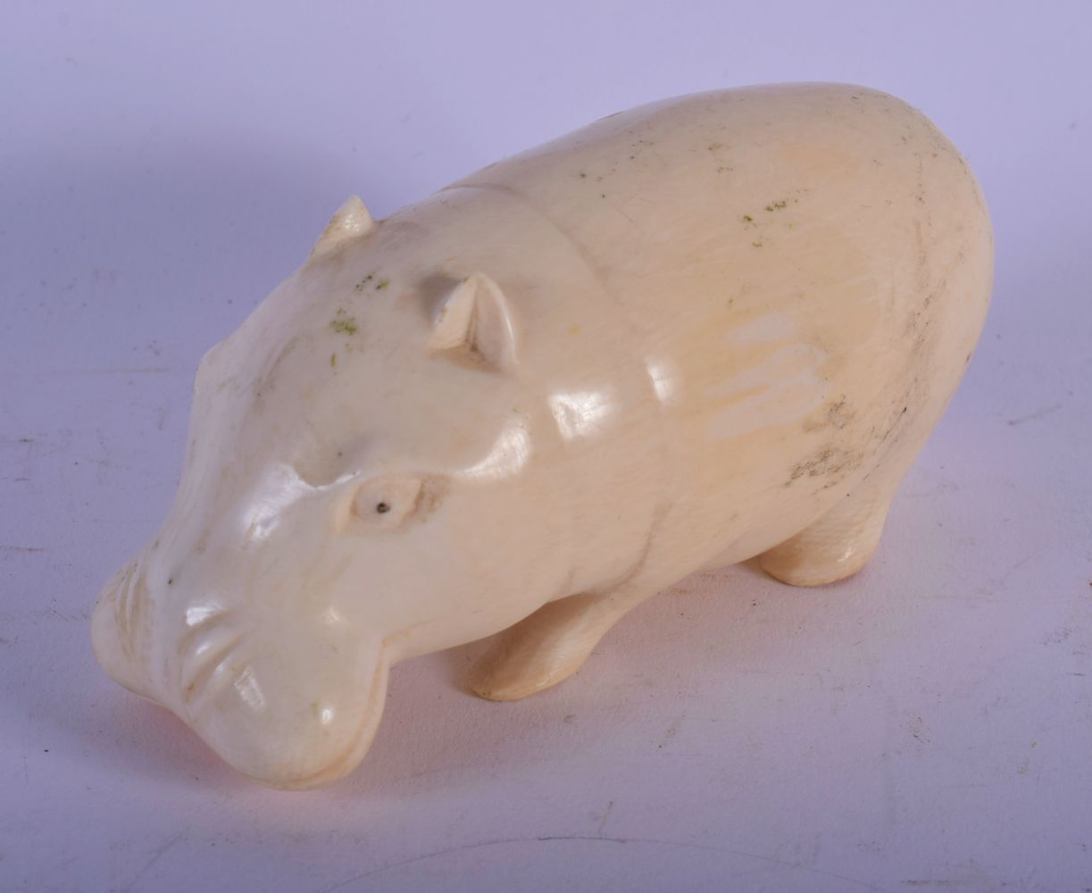 AN EARLY 20TH CENTURY AFRICAN CARVED IVORY FIGURE OF A HIPPO C1920. 9 cm x 4 cm.