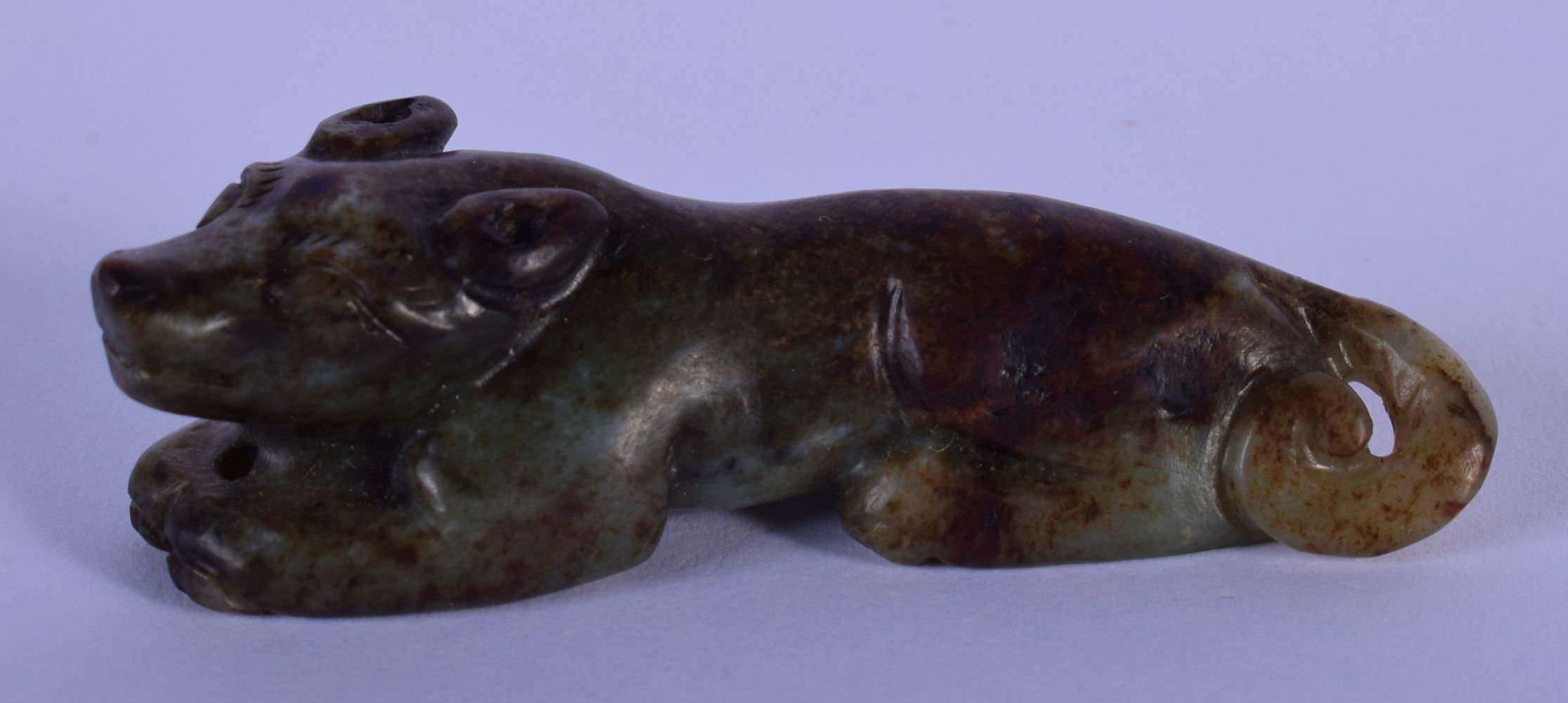 A 19TH CENTURY CHINESE CARVED MUTTON JADE FIGURE OF A BEAST Qing, with black inclusions, modelled re