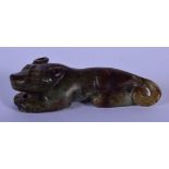 A 19TH CENTURY CHINESE CARVED MUTTON JADE FIGURE OF A BEAST Qing, with black inclusions, modelled re
