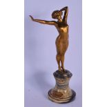 AN ART DECO BRONZE FIGURE OF A NUDE DANCER modelled upon a marble plinth. 23 cm high.
