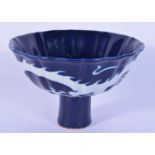 A Chinese porcelain blue ground stem cup decorated with dragons 12 x 16cm.