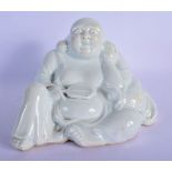 A CHINESE QING DYNASTY DEHUA TYPE BLANC DE CHINE FIGURE OF A BUDDHA modelled holding a fan. 18 cm x