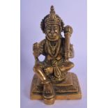AN INDIAN BRONZE FIGURE OF A SEATED TIGER GOD modelled holding a sceptre. 12 cm x 6 cm.