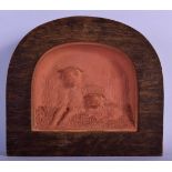 A 19TH CENTURY EUROPEAN TERRACOTTA DOG KENNEL PLAQUE depicting two dogs who by repute walked for 3 d