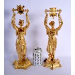 A PAIR OF CONTINENTAL SILVER GILT FIGURAL SWING CANDLESTICKS upon a hexagonal base. 2450 grams. 40 c