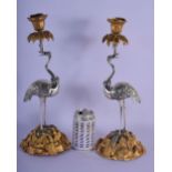 A LOVELY PAIR OF 19TH CENTURY FRENCH SILVER BRONZED AND ORMOLU CANDLESTICKS modelled as standing sto