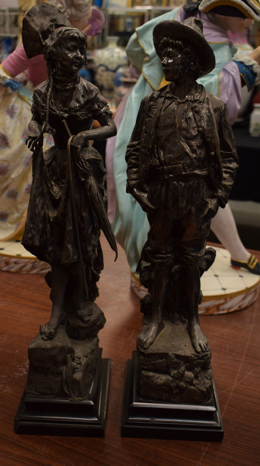 A PAIR OF 19TH CENTURY EUROPEAN SILVERED BRONZE FIGURES modelled as a male and female. 51 cm high.