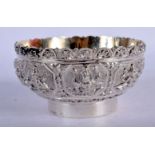 AN INDIAN WHITE METAL BOWL HEAVILY EMBOSSED WITH DEITIES. 8.7cm diameter, 4.5cm high, weight 123g