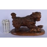 A VERY RARE 19TH CENTURY BAVARIAN BLACK FOREST FIGURAL INKWELL modelled as a hound clutching a scowl