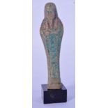 A small Egyptian carved stone statue on a stand 11cm.