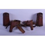 A MILITARY ISSUE LEATHER DOUBLE GUN HOLSTER together with leather archery armguards. (3)