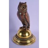 A LATE VICTORIAN MIXED METAL COPPER AND BRASS OWL INKWELL modelled with glass eyes. 23.5 cm high.