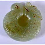 A JADE ROUNDEL CARVED WITH A DRAGON. 5.2cm diameter, weight 55.4g