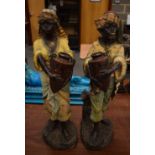 A PAIR OF ANTIQUE AUSTRIAN COLD PAINTED TERRACOTTA FIGURES modelled as water carriers. 69 cm x 20 cm