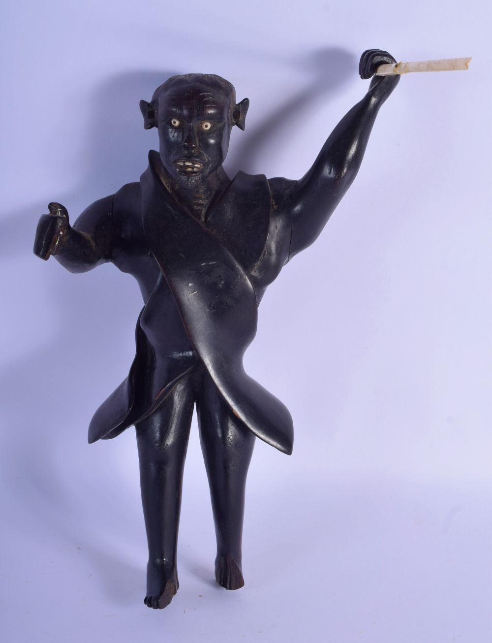 A RARE EARLY 20TH CENTURY TRIBAL HARDWOOD FIGURE OF A HUNTER modelled holding a bone spear. 32 cm x