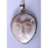 A SILVER CARVED STONE MOON HEAD PENDANT. 4 cm x 4.5 cm.