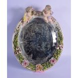 AN ANTIQUE GERMAN MEISSEN STYLE PORCELAIN MIRROR modelled holding a floral wreath. 30 cm x 22 cm.