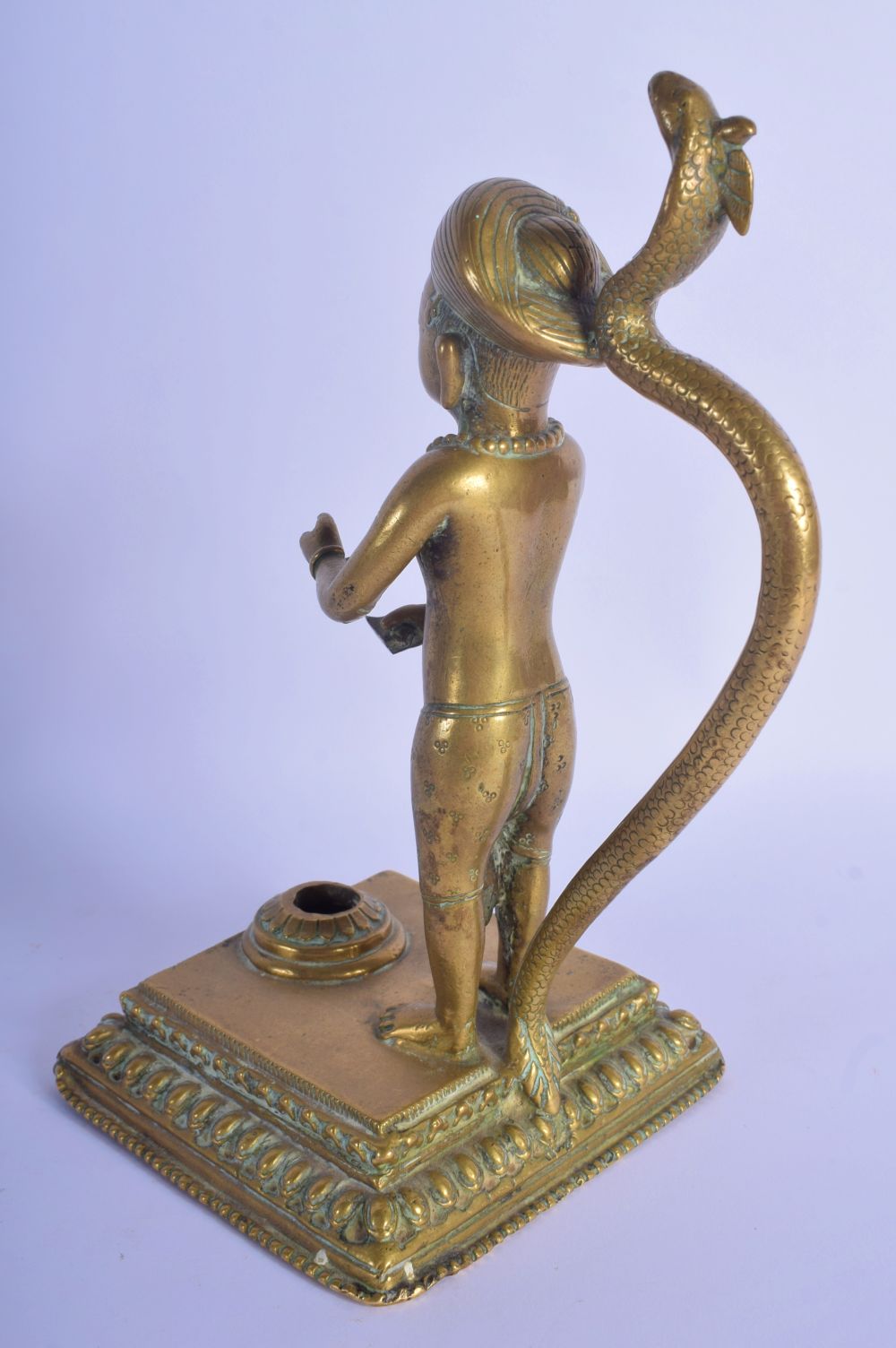 A CHARMING EARLY 19TH CENTURY INDIAN BRONZE FIGURE OF A BOY modelled with a serpent upon a square pl - Image 2 of 7