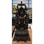 A LARGE ASIAN BRONZE FIGURE OF A BUDDHA modelled with attendants. 70 cm x 50 cm.