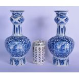 A PAIR OF DUTCH DELFT BLUE AND WHITE PORCELAIN VASES decorated with boats. 28 cm high.