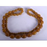 A STRING OF HORN BEADS Length 66cm, weight 48g, largest bead 13.8mm