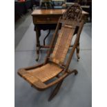 AN UNUSUAL 19TH CENTURY ANGLO INDIAN ASIAN HARDWOOD FOLDING CHAIR carved with flowers and buddhistic