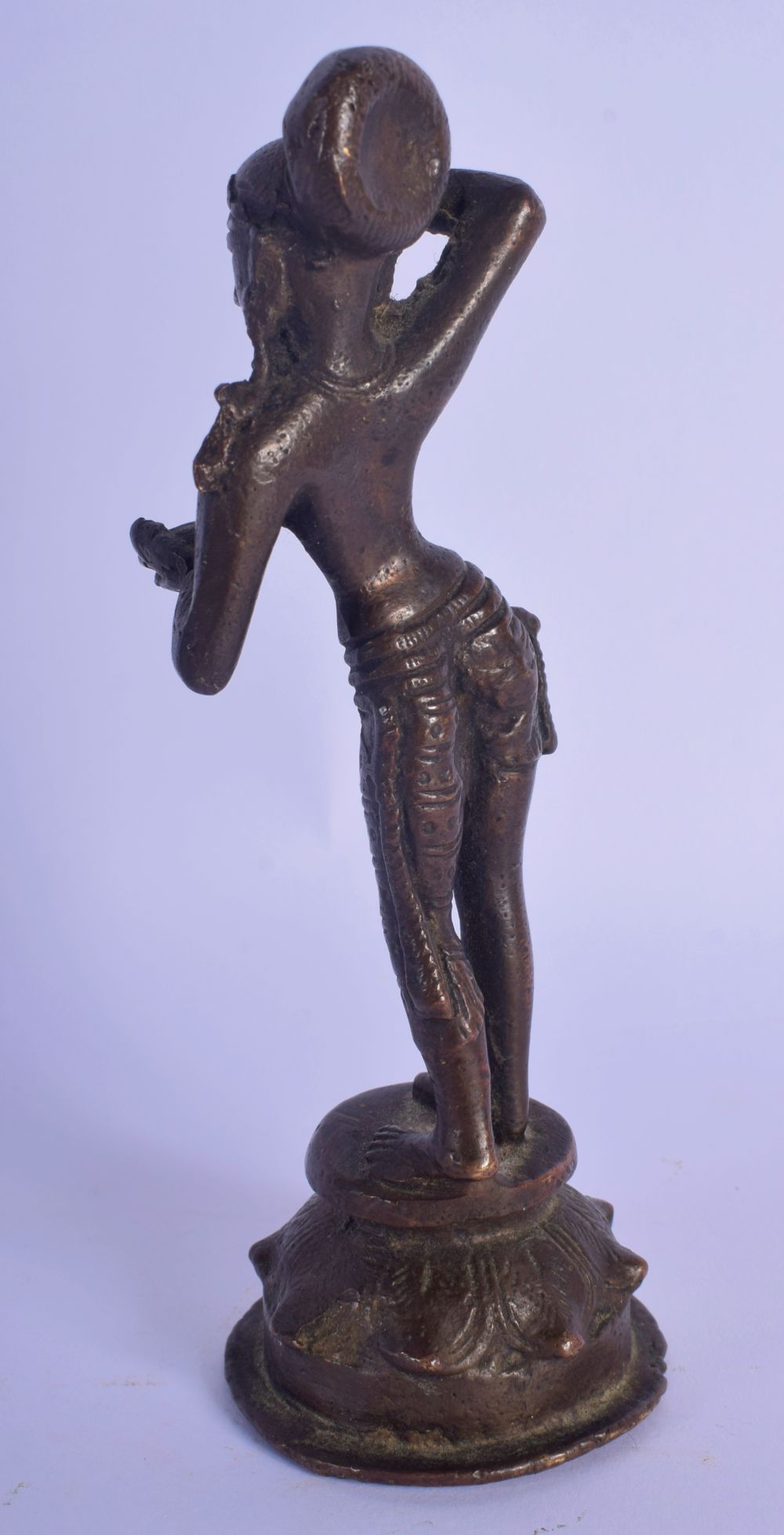 A 19TH CENTURY INDIAN BRONZE FIGURE OF A STANDING BUDDHIST DEITY modelled applying a motif to her fo - Image 2 of 4