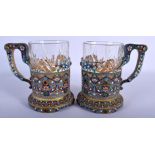 A PAIR OF CONTINENTAL SILVER AND ENAMEL CUP HOLDERS decorated with gems and foliage. Silver 703 gram