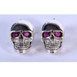 A PAIR OF SILVER SKULL EARRINGS. Stamped 925, 1.3cm x 0.9cm, weight 3.5g.