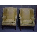 A pair of antique upholstered wing back Arm Chairs . 107 x 78 x 80 cm