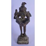 A 17TH/18TH CENTURY INDIAN BRONZE FIGURE OF A STANDING BUDDHIST DEITY modelled with a bird holding a
