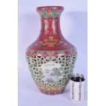 A large Chinese porcelain polychrome vase with open work decoration and panels depicting landscapes