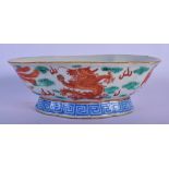A LATE 19TH CENTURY CHINESE IRON RED GLAZED PORCELAIN OVAL BOWL Qing, painted with dragons. 18 cm x
