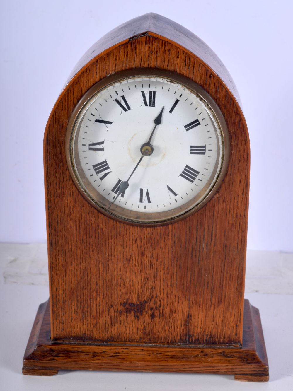 A small wooden surround clock 21cm.