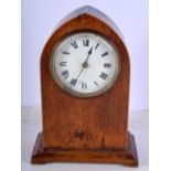 A small wooden surround clock 21cm.
